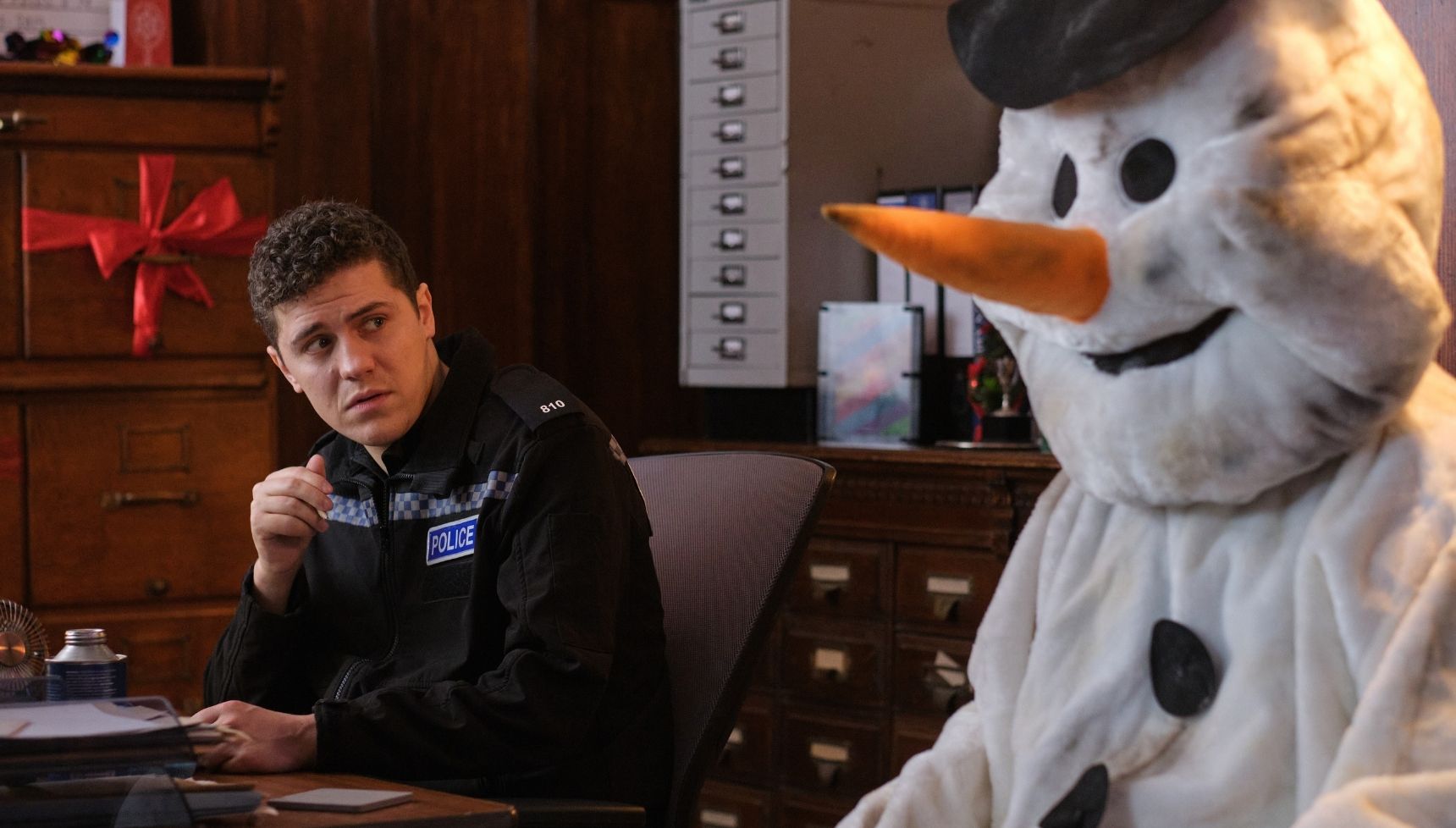 Kelby looking at someone dressed as a snowman in the Beyond Paradise Christmas special 2025
