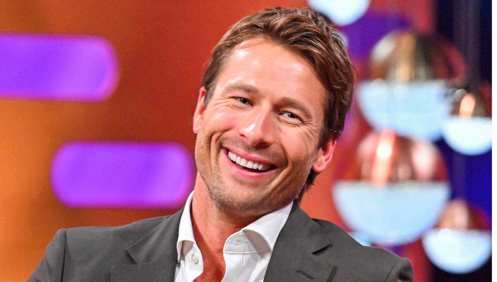 Glen Powell smiling on The Graham Norton Show