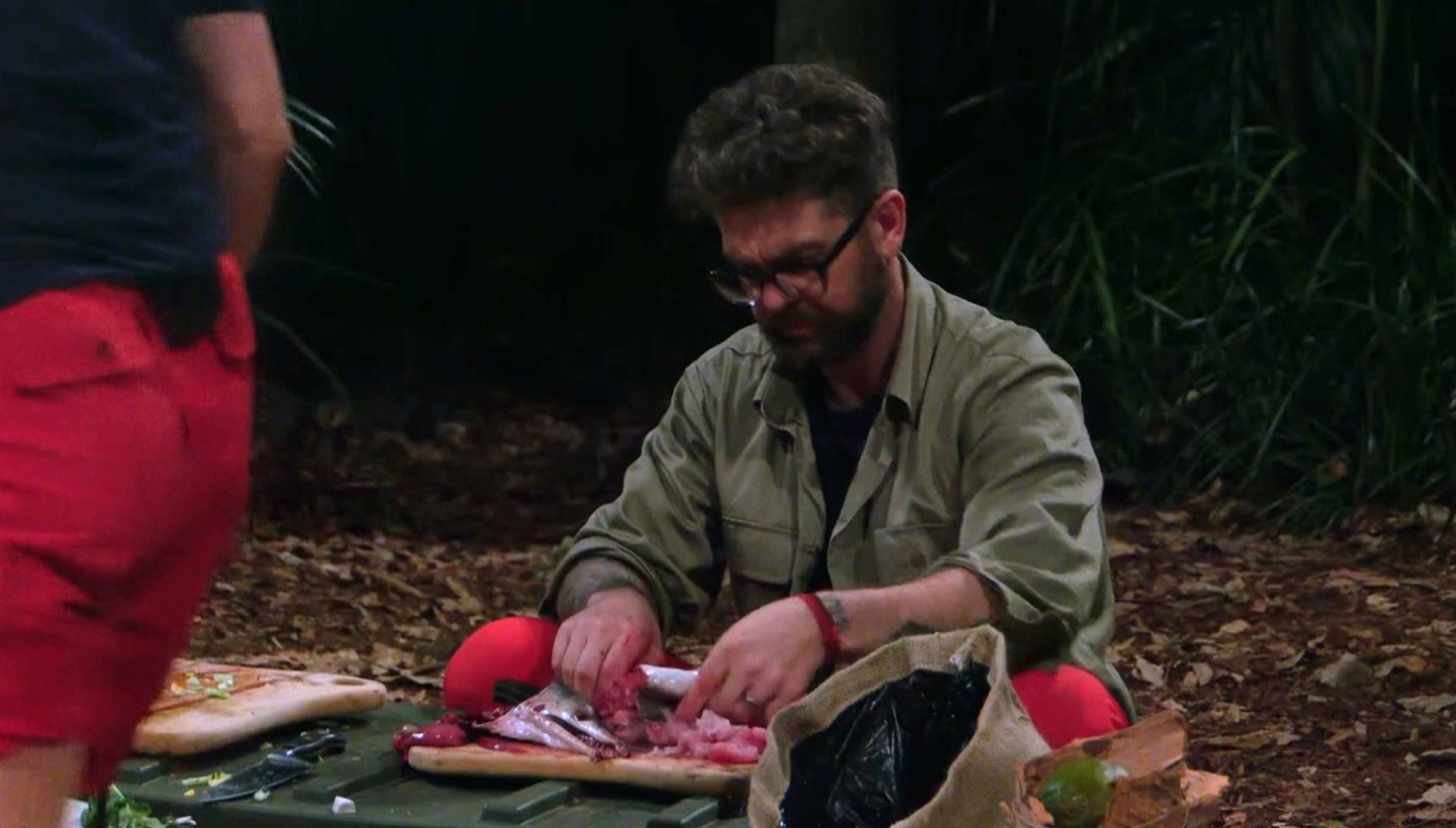 Jack Osbourne gutting a fish on I'm A Celeb