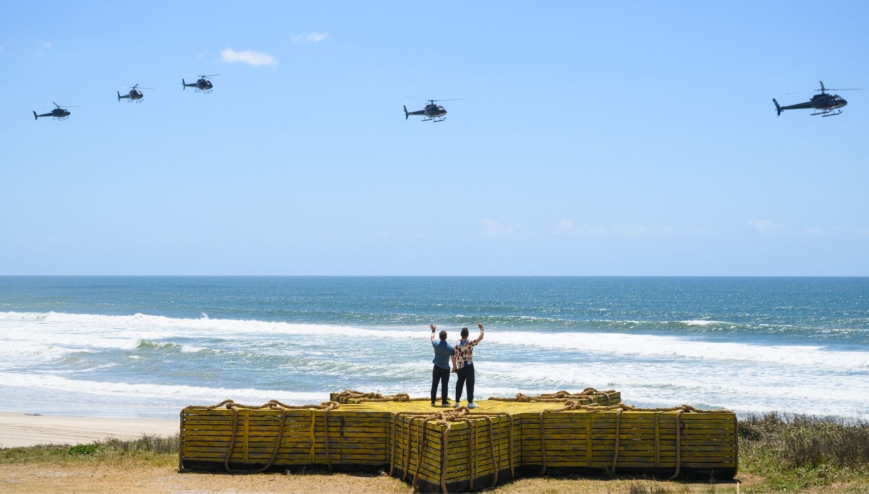 Ant and Dec waving from the beach