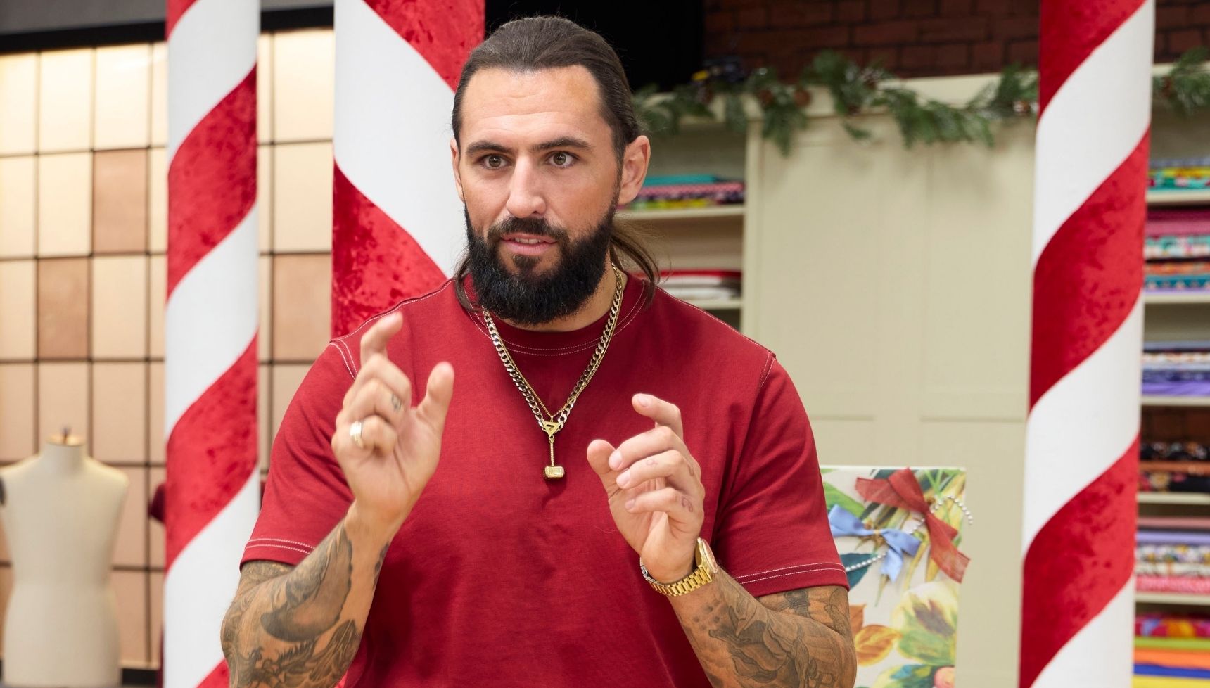 Tom Wilson in a red top for The Great Christmas Sewing Bee 2025