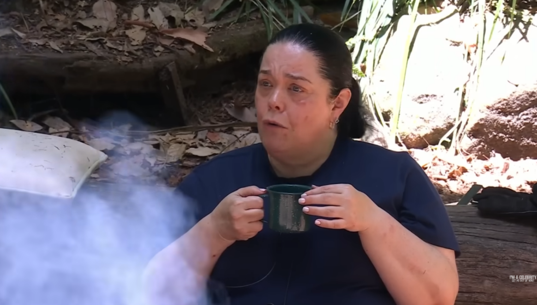 Lisa Riley drinking a cup of tea around the camp fire