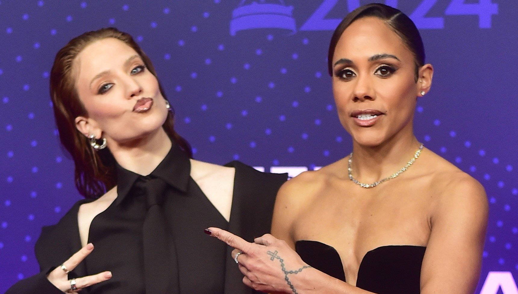 Jess Glynne and Alex Scott pose together on a red carpet