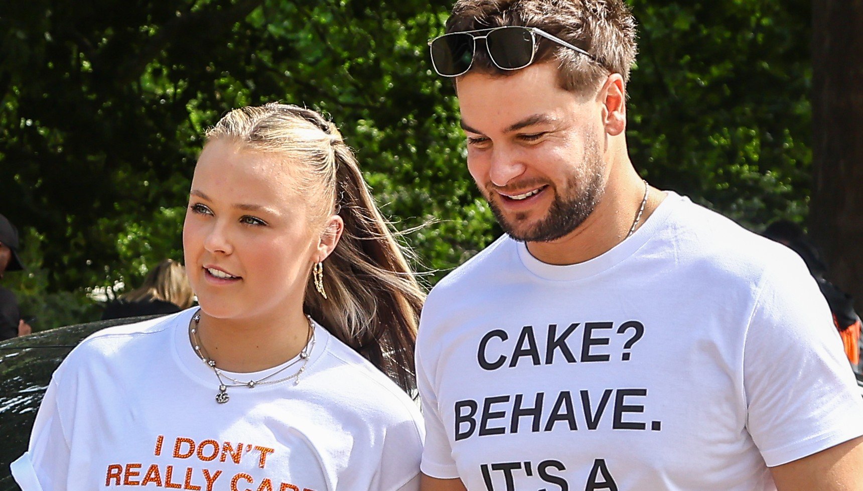 Jojo Siwa and Chris Hughes walking together