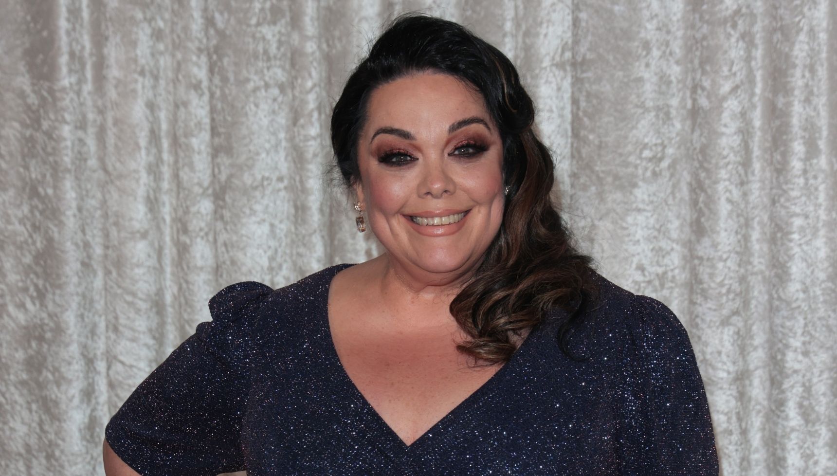 Lisa Riley on the red carpet in a navy dress