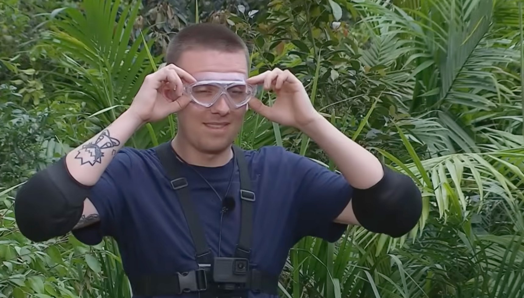 Aitch on I'm A Celeb showing arm tattoo