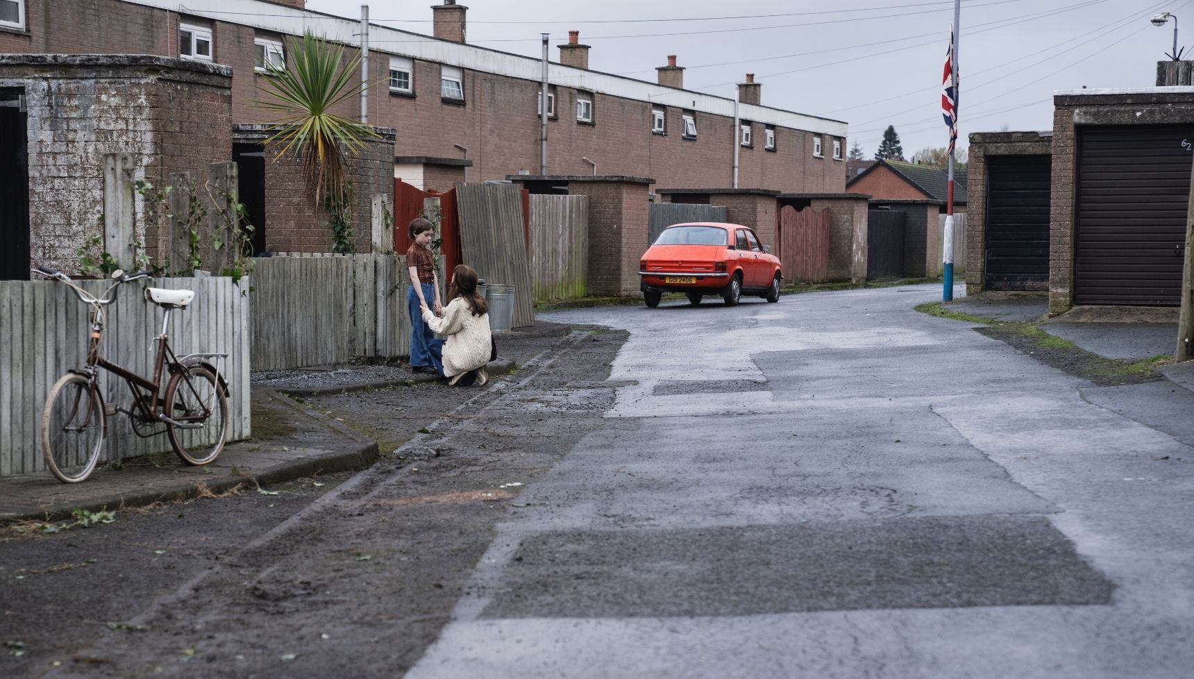 Cushla Lavery (Lola Petticrew) and Davy McGeown (Daithi O Haragain) on an empty street talking