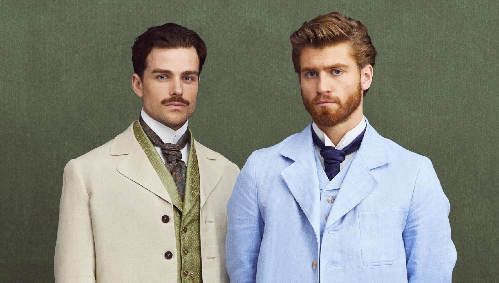 Joylon and Soames in smart suits with a green background behind them