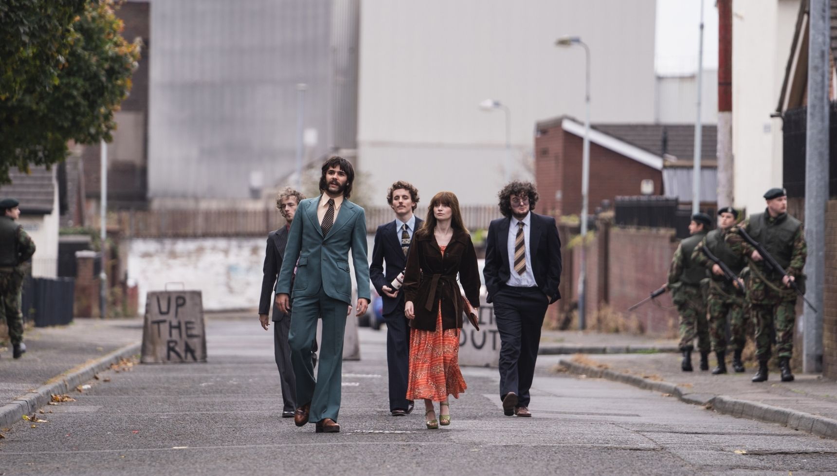 Trespasses filming locations: Oisin Thompson as Gerry Harkin and Lola Petticrew as Cushla Lavery walking along a road with friends