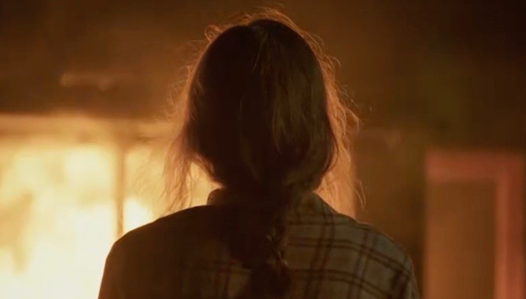 Lana Mair standing in front of burning house in Shetland