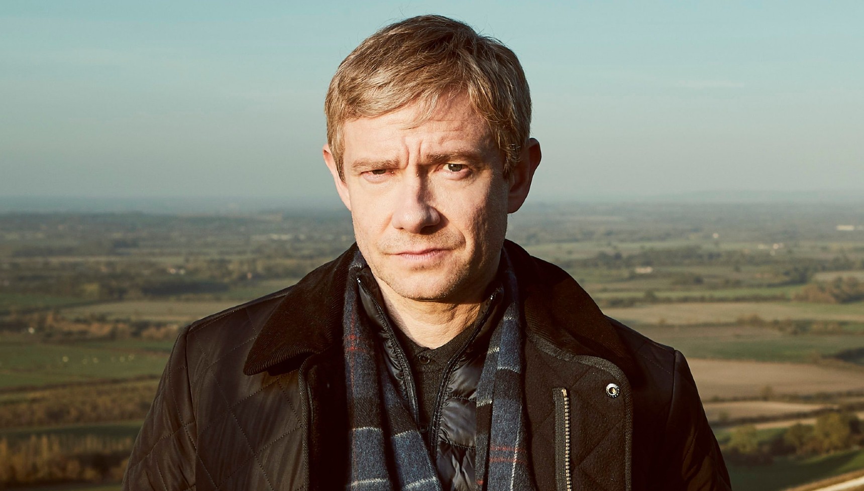 Martin Freeman standing in front of a countryside view in A Confession