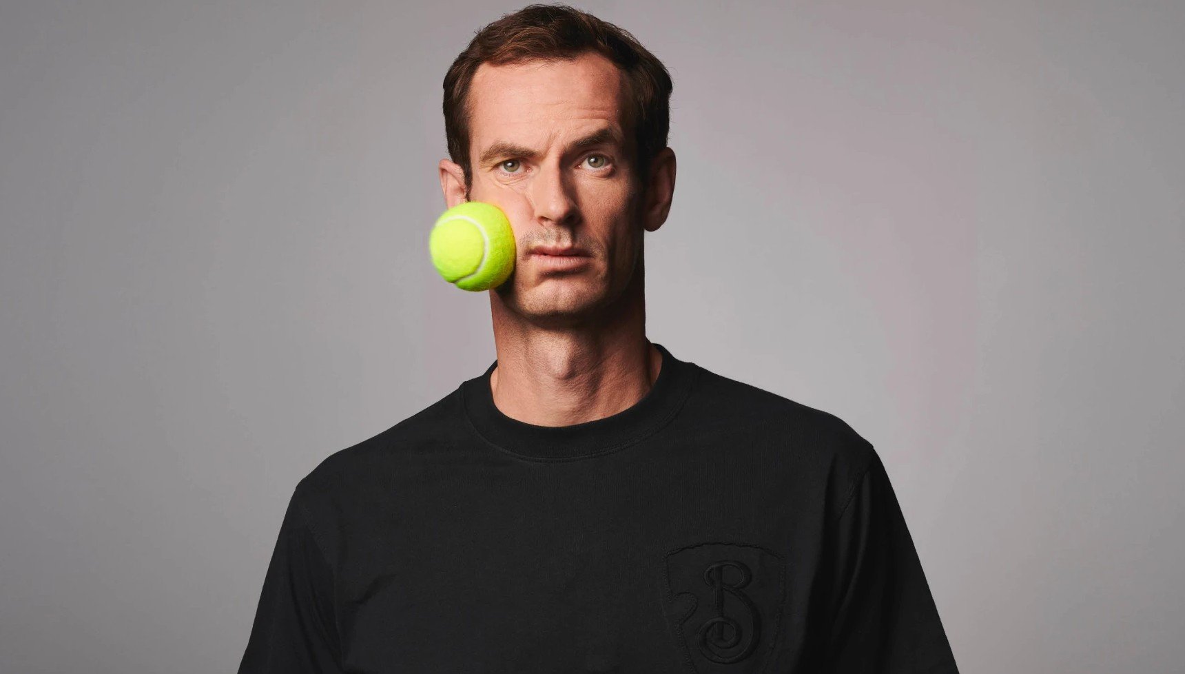 Andy Murray with a tennis ball hitting his face 