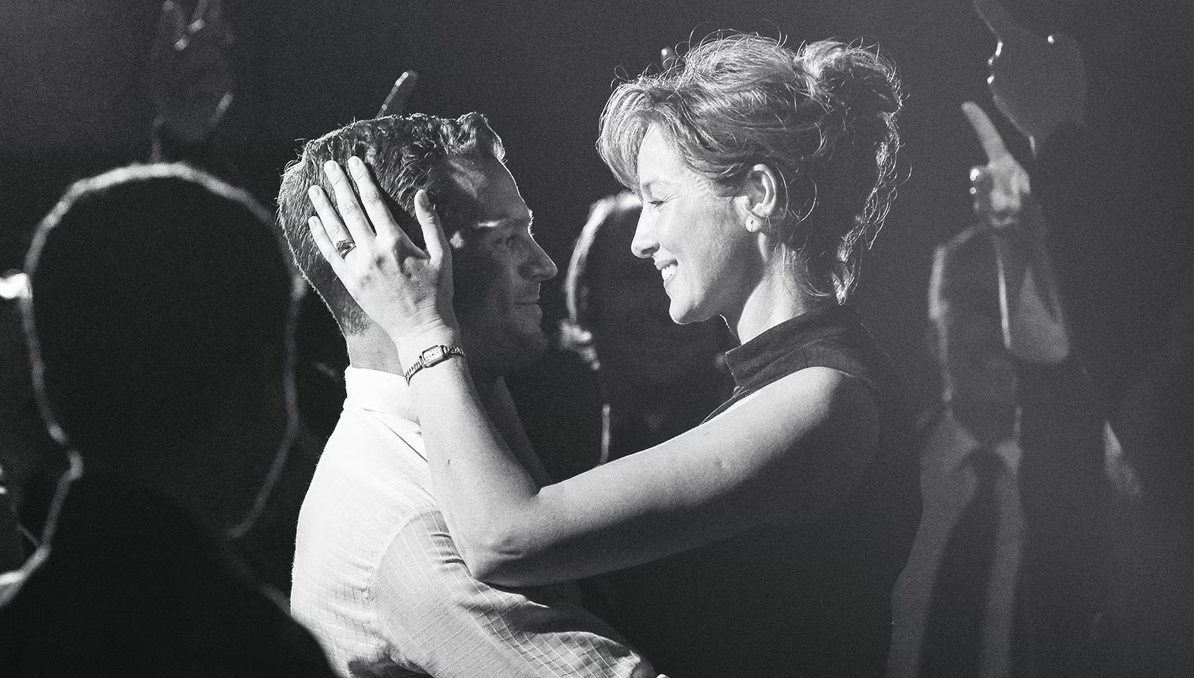 Jamie Dornan smiling and holding Caitríona Balfe