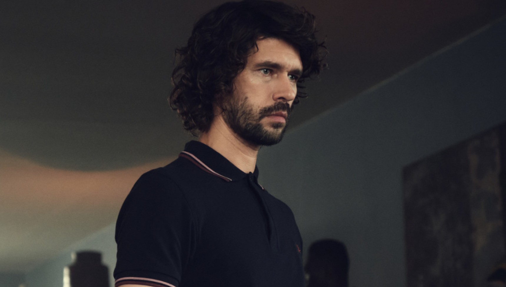 Ben Whishaw wearing a black polo shirt in Black Doves