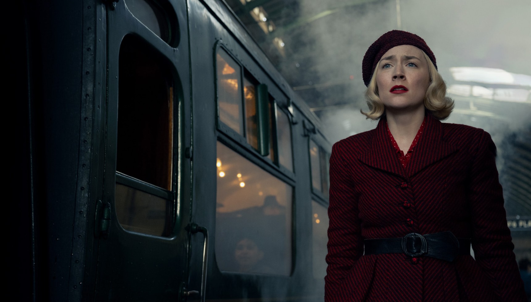 Saoirse Ronan stood next to a London train in Blitz
