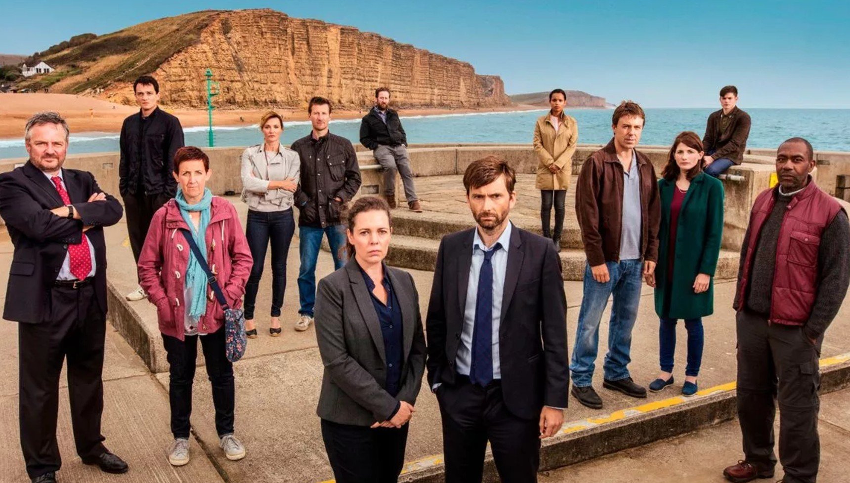 David Tennant and Olivia Colman on the pier in Broadchurch series 3 with the rest of the cast