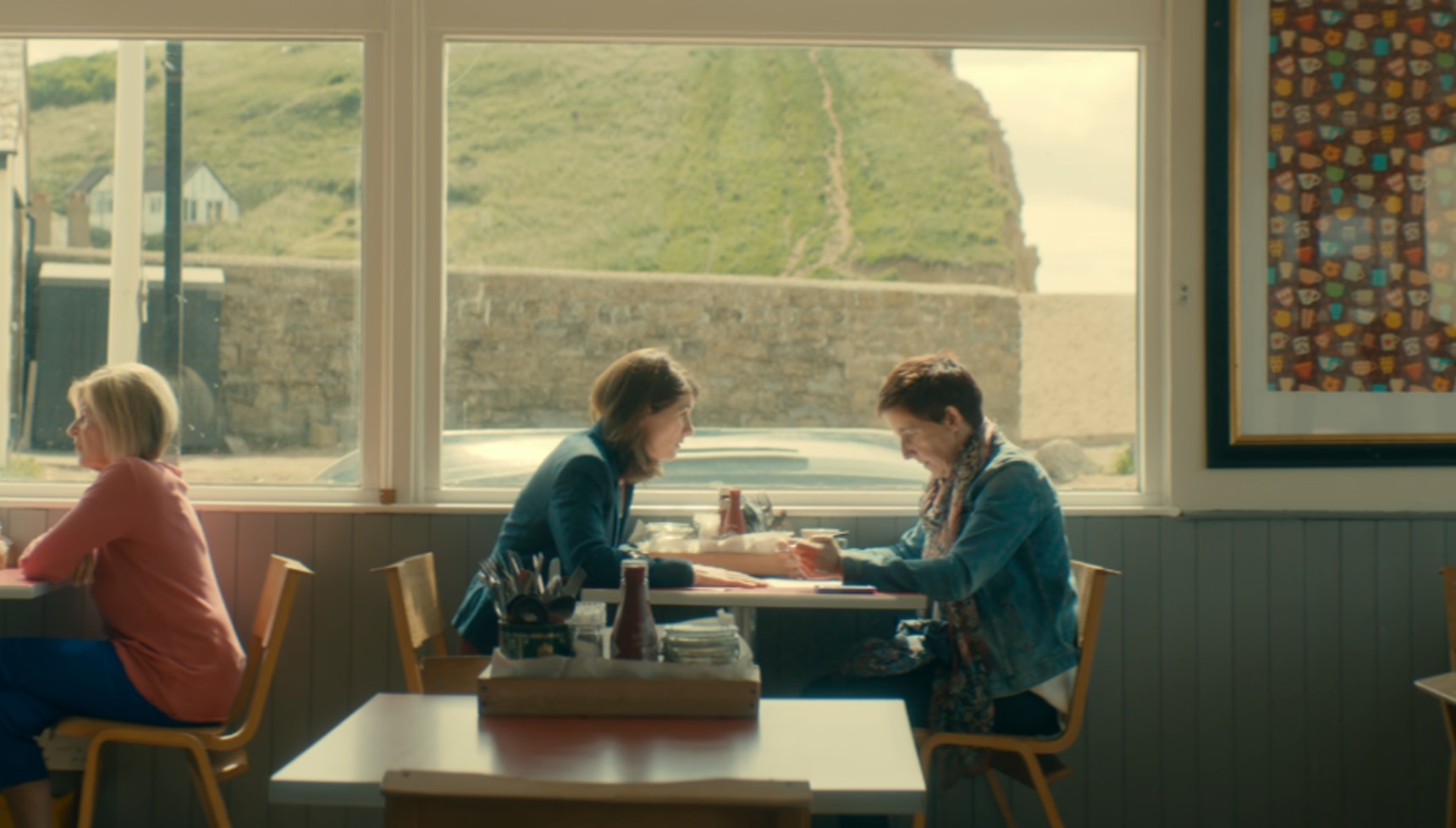 Beth and Trish sitting at a table in a cafe in Broadchurch series 3