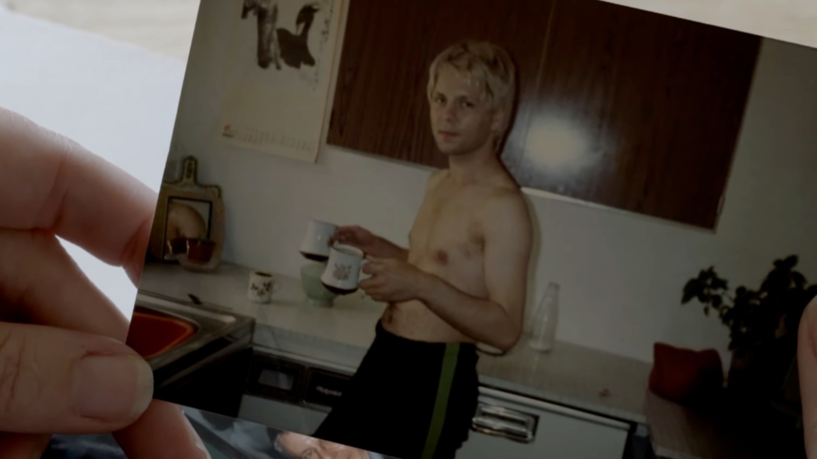 An old photo of Carl Stotter holding cups of tea