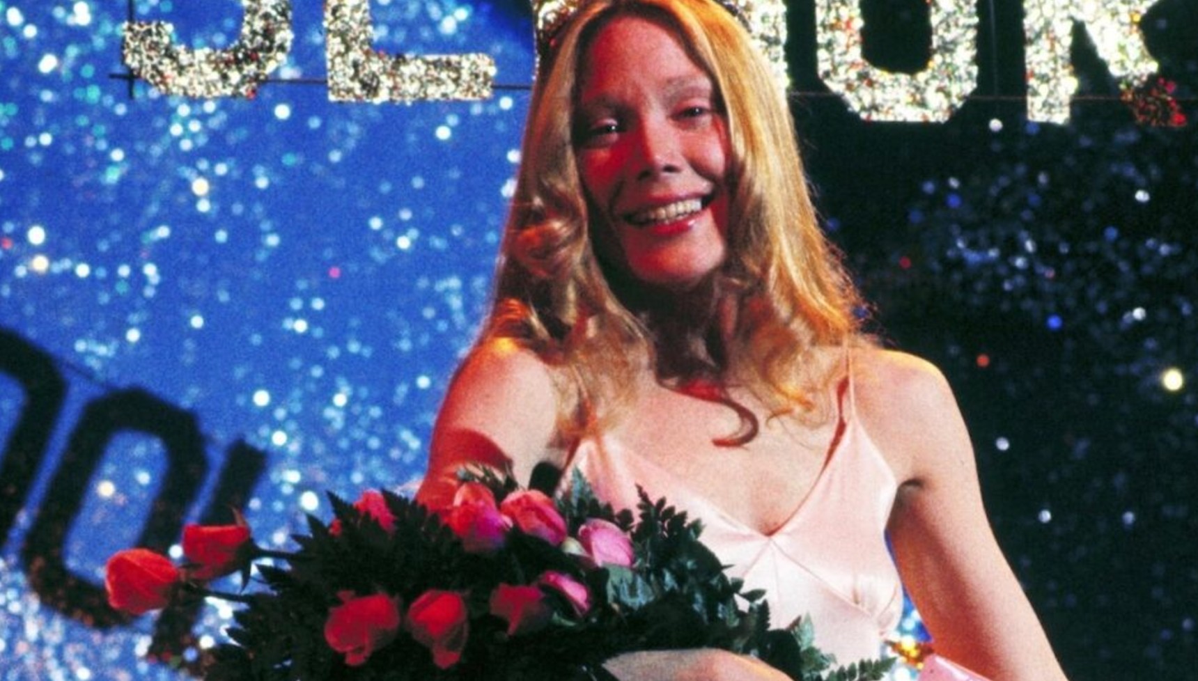 Sissy Spacek holding a bouquet of flowers