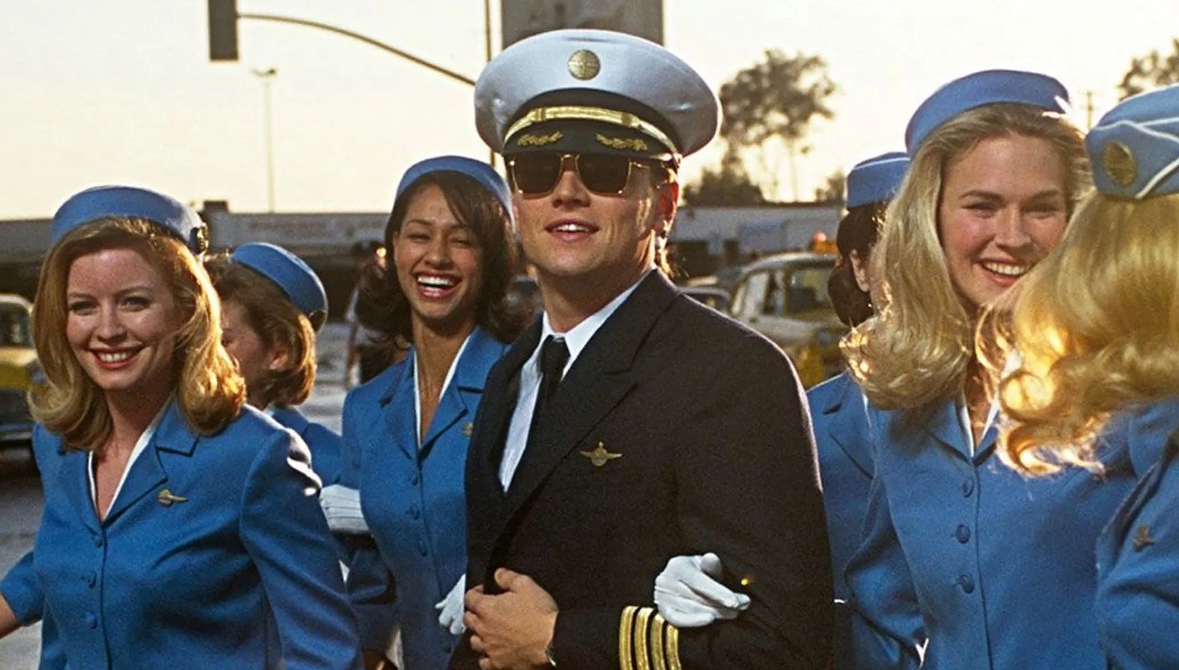 Leonardo DiCaprio dressed as a pilot and surrounded by women in Catch Me If You Can