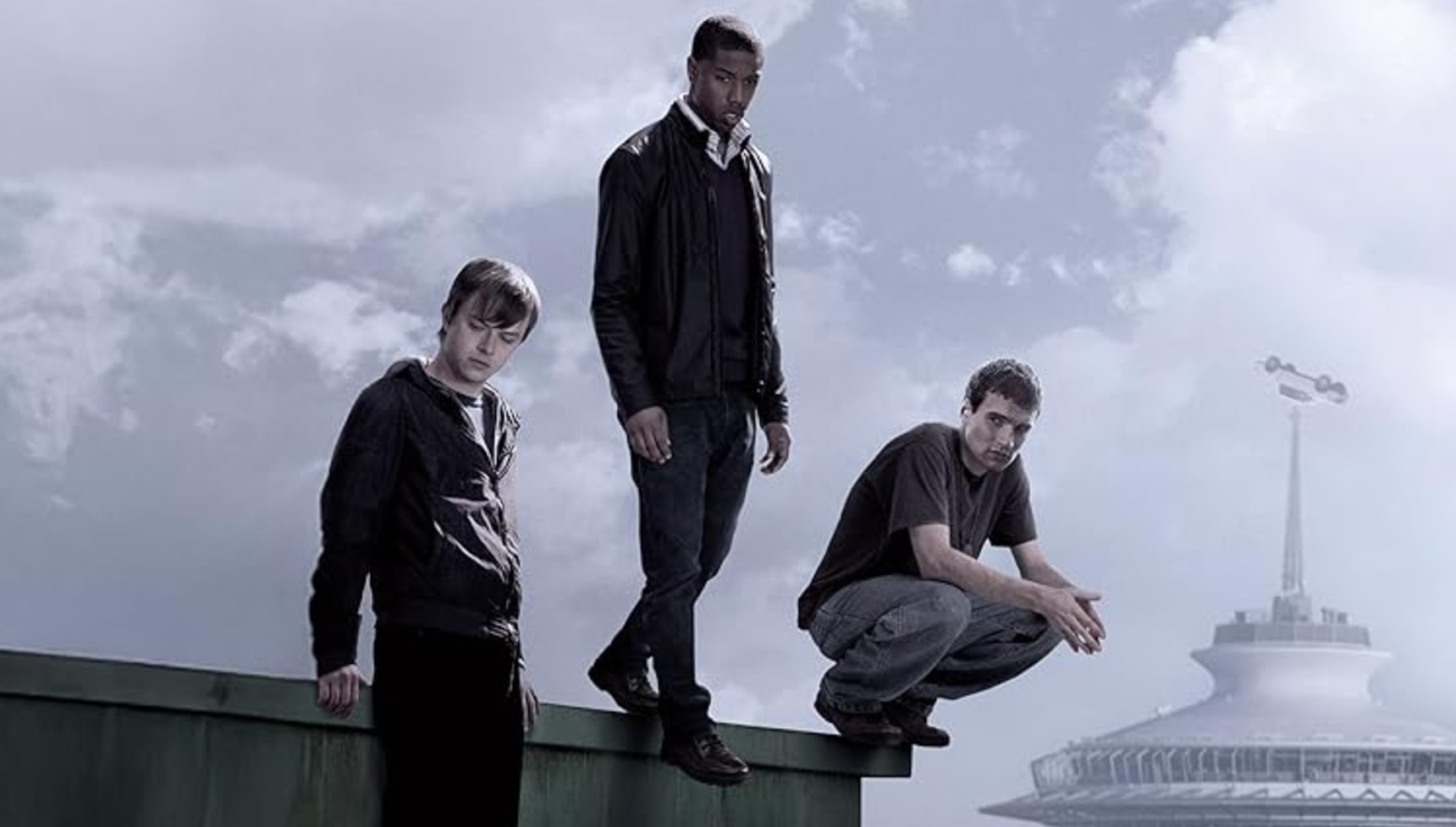 Dane DeHaan, Michael B. Jordan, and Alex Russell standing on the edge of a rooftop in Seattle in Chronicle