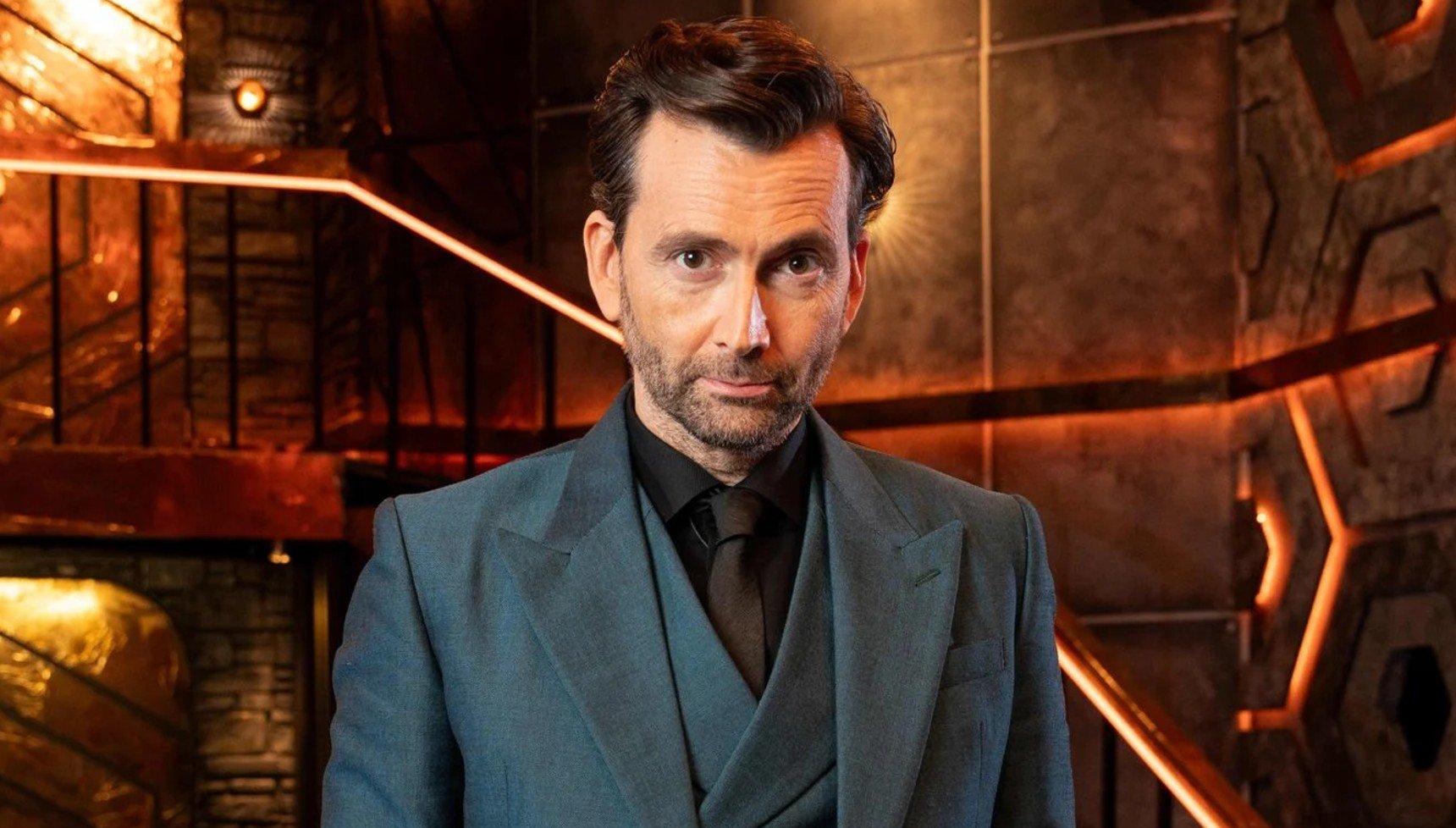 David Tennant in a teal suit on the set of the Genius Game