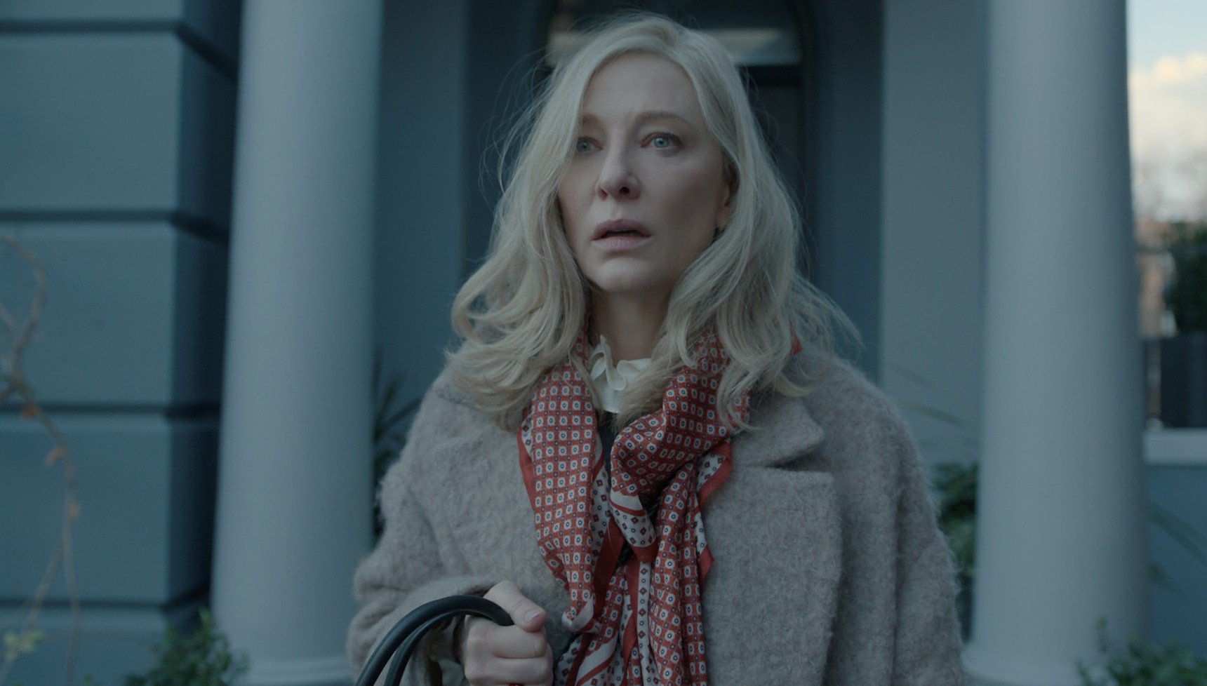 A devastated woman holding her handbag