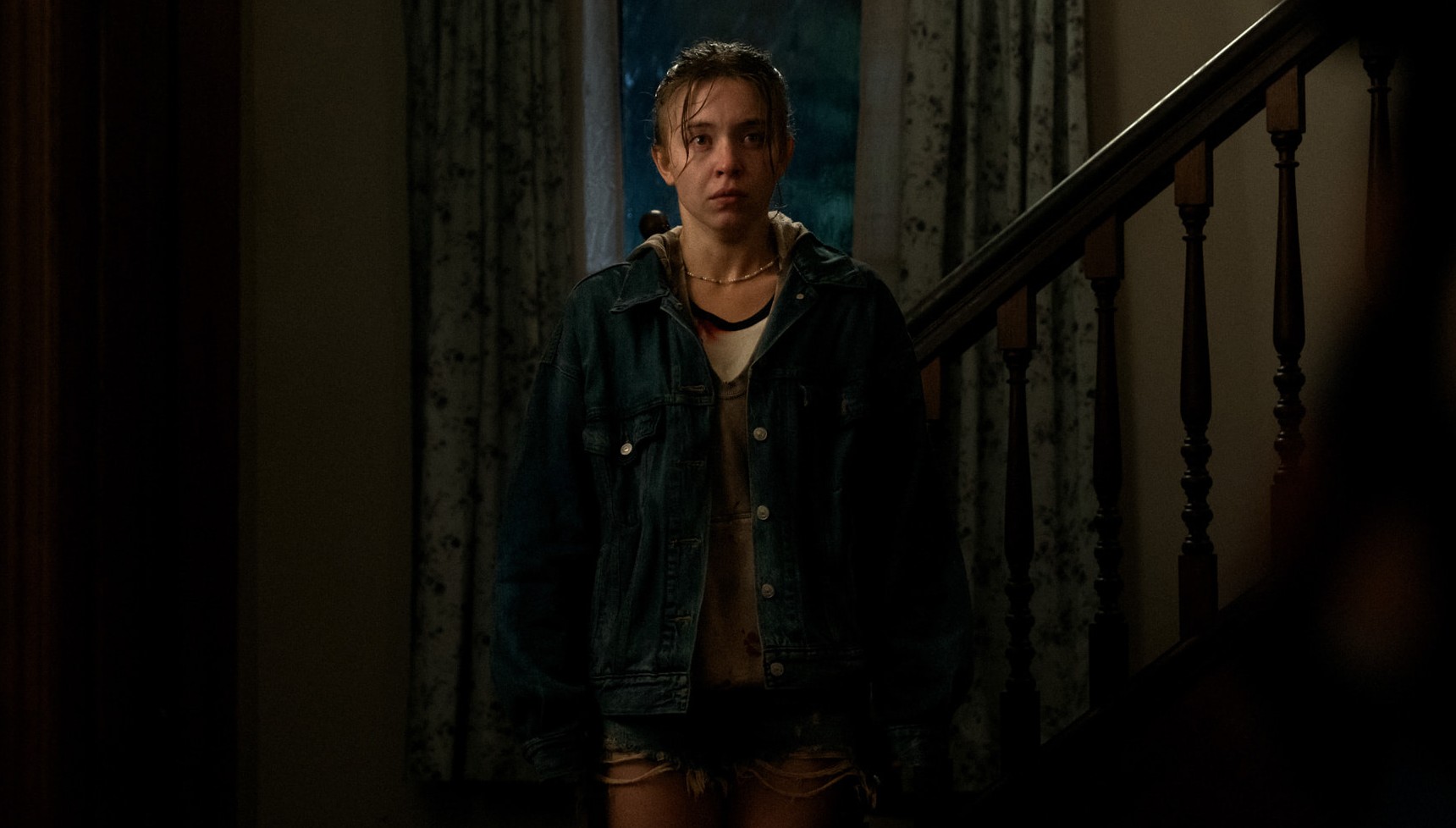 Sydney Sweeney drenched at the bottom of some stairs