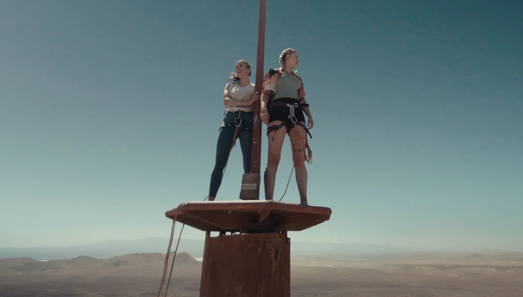 Grace Caroline Currey and Virginia Gardner standing on top of a TV tower in Fall