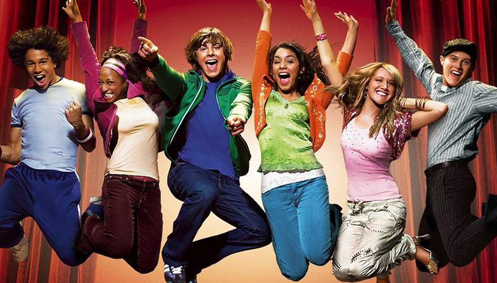 The cast of High School Musical jumping in the air and smiling