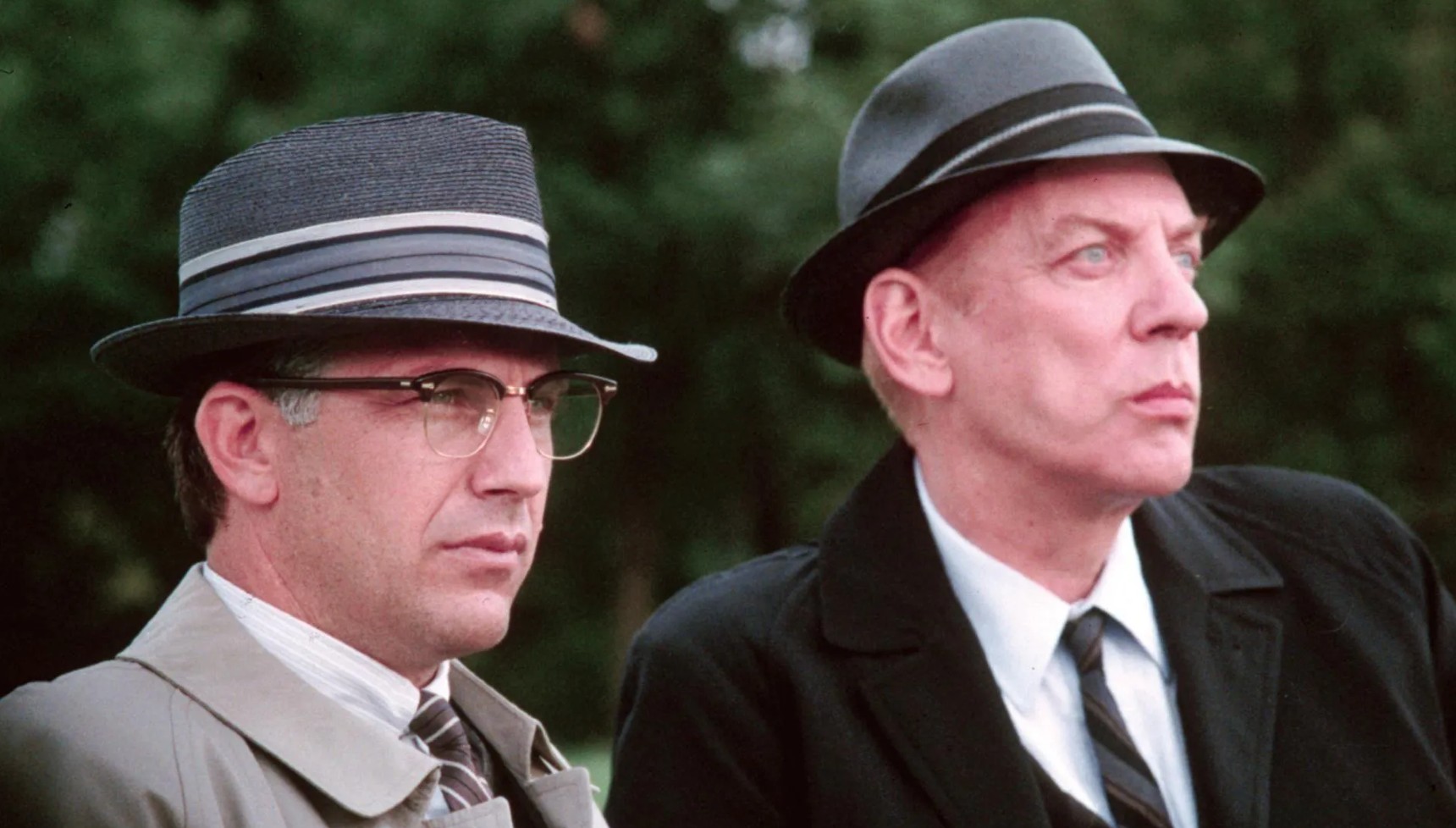 Kevin Costner sitting next to Donald Sutherland in JFK