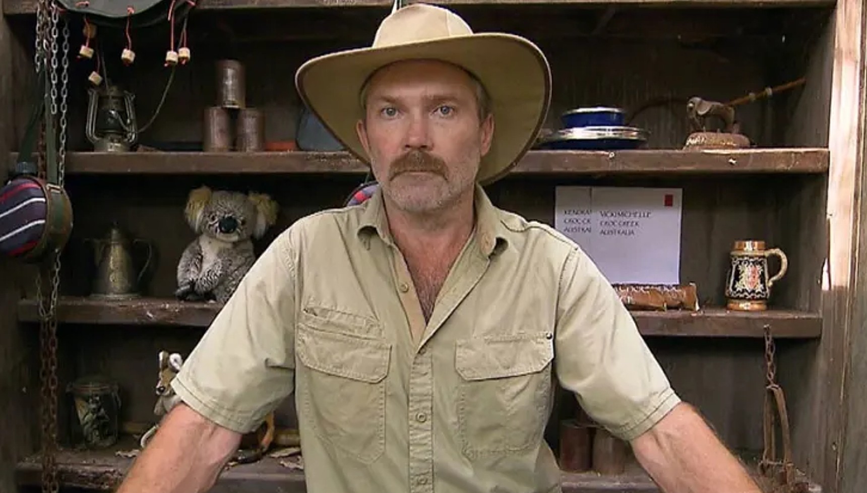 Kiosk Keith standing at his table in I'm A Celebrity