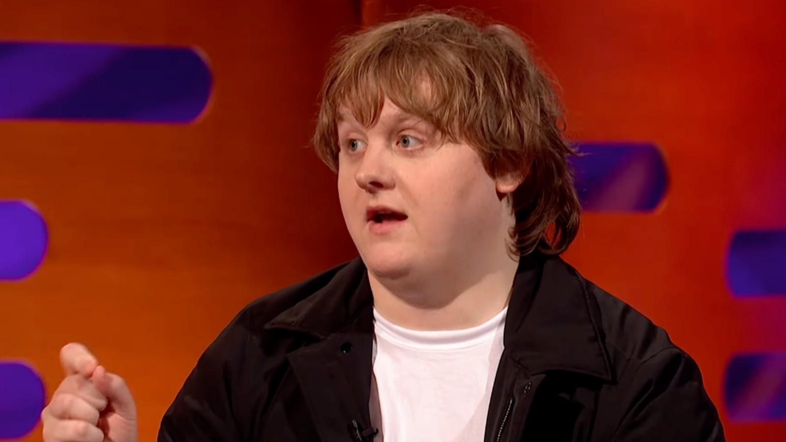 Lewis Capaldi wearing a black shirt and white t-shirt on The Graham Norton Show