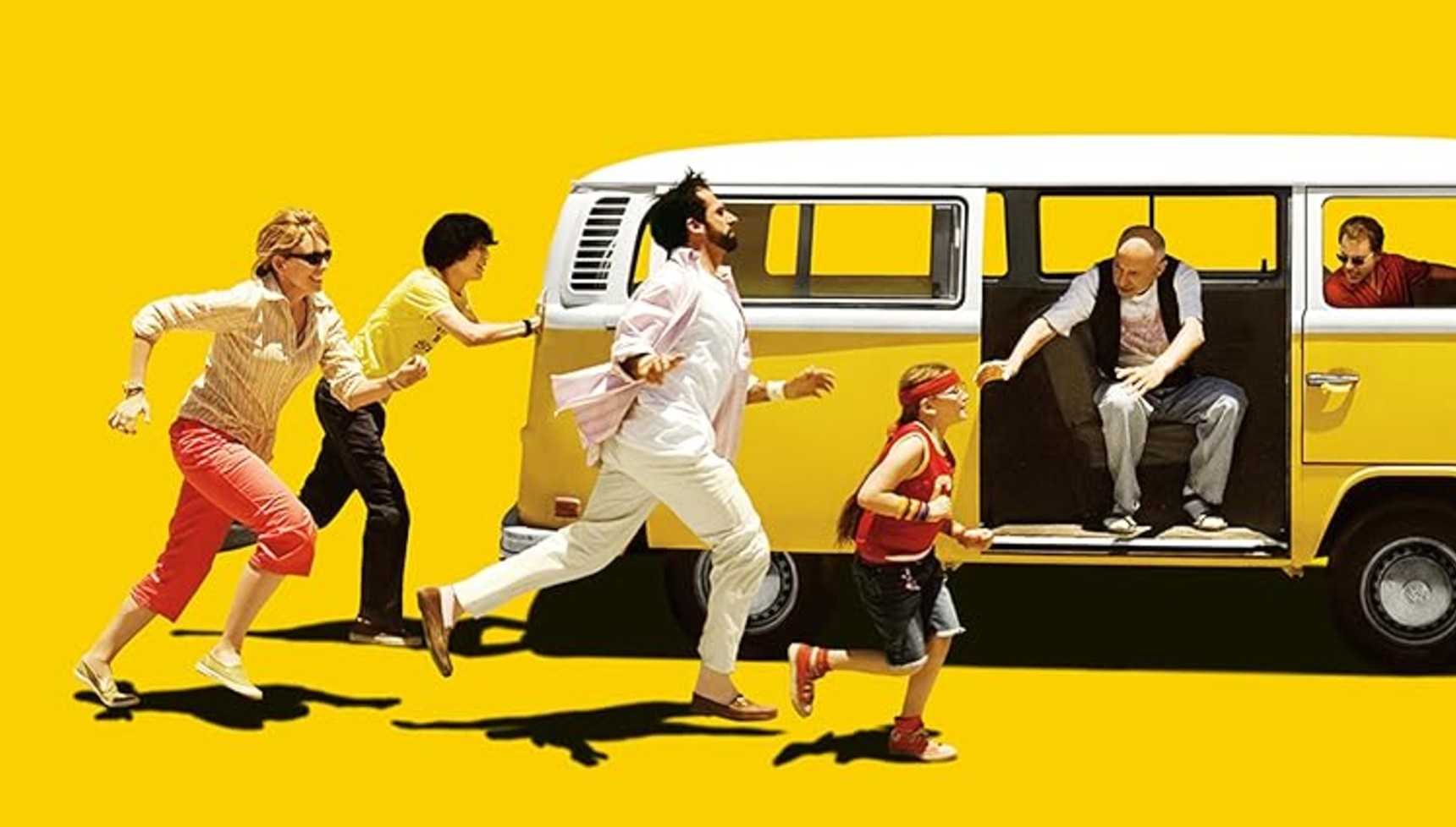 The cast of Little Miss Sunshine running after a yellow Volkswagen camper van