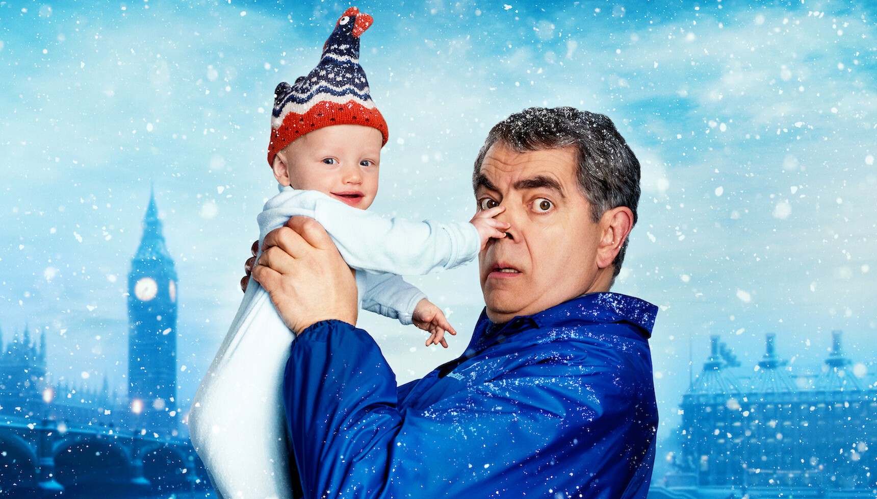 Rowan Atkinson holding a baby on the poster for Man vs Baby 