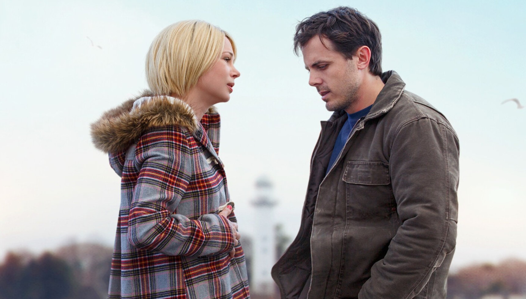 Michelle Williams standing beside Casey Affleck in Manchester by the Sea