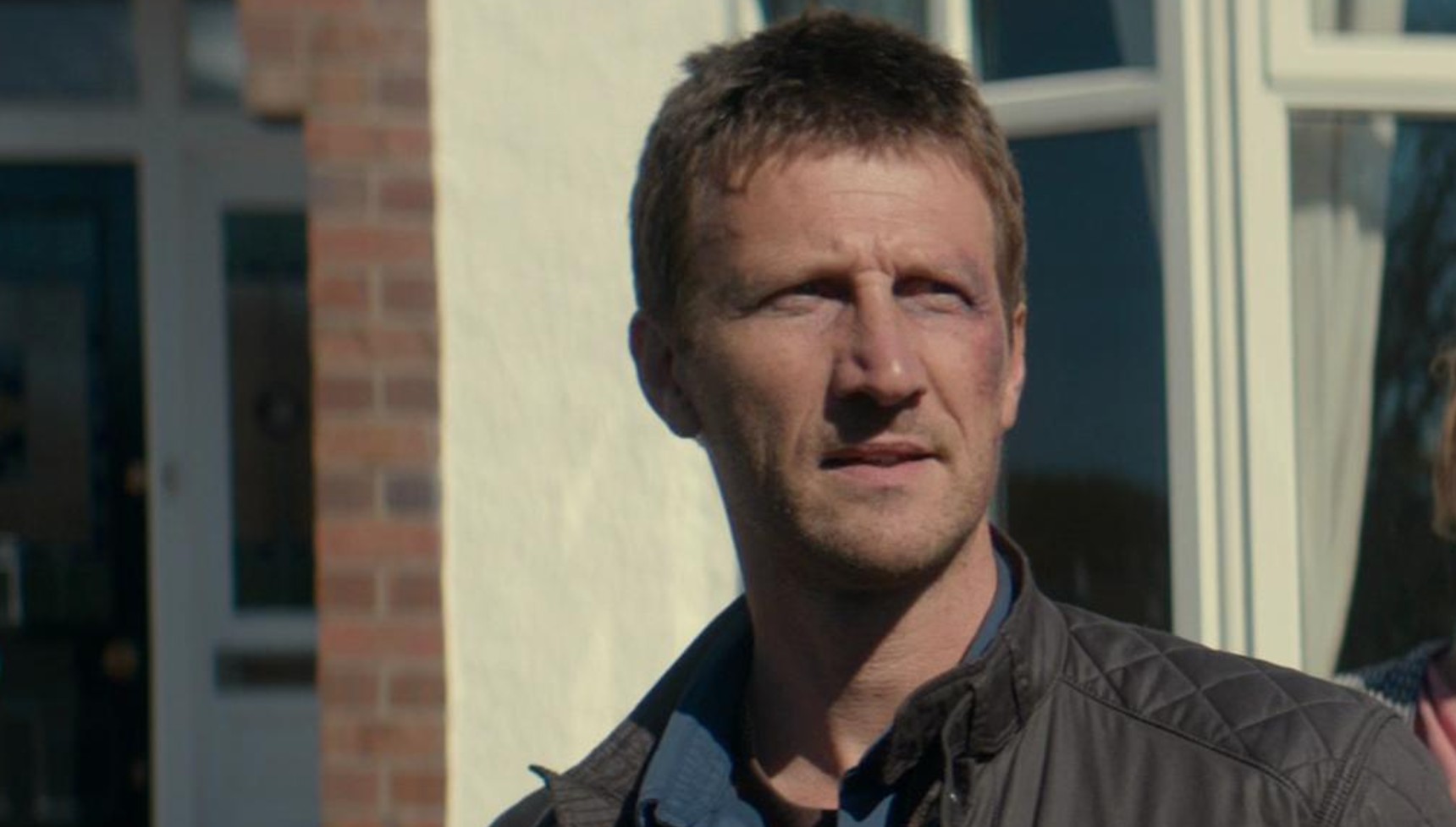 Mark Bazeley standing outside a house in Broadchurch