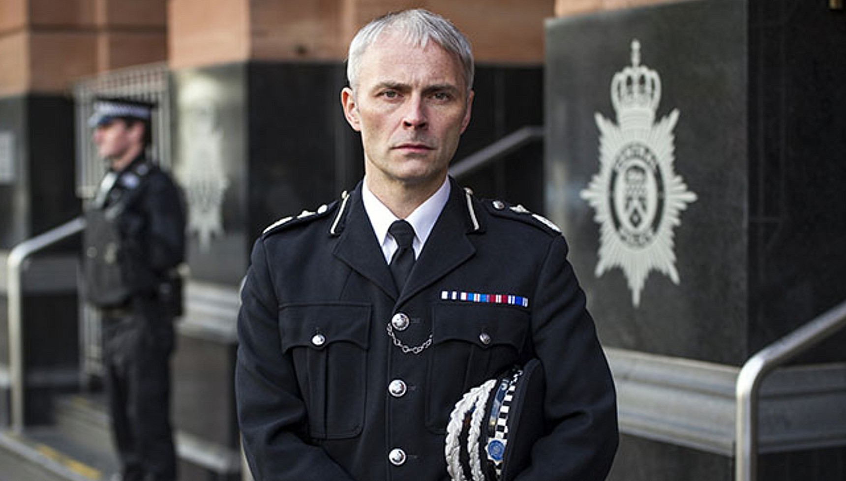 Mark Bonnar as Mike Dryden in police uniform