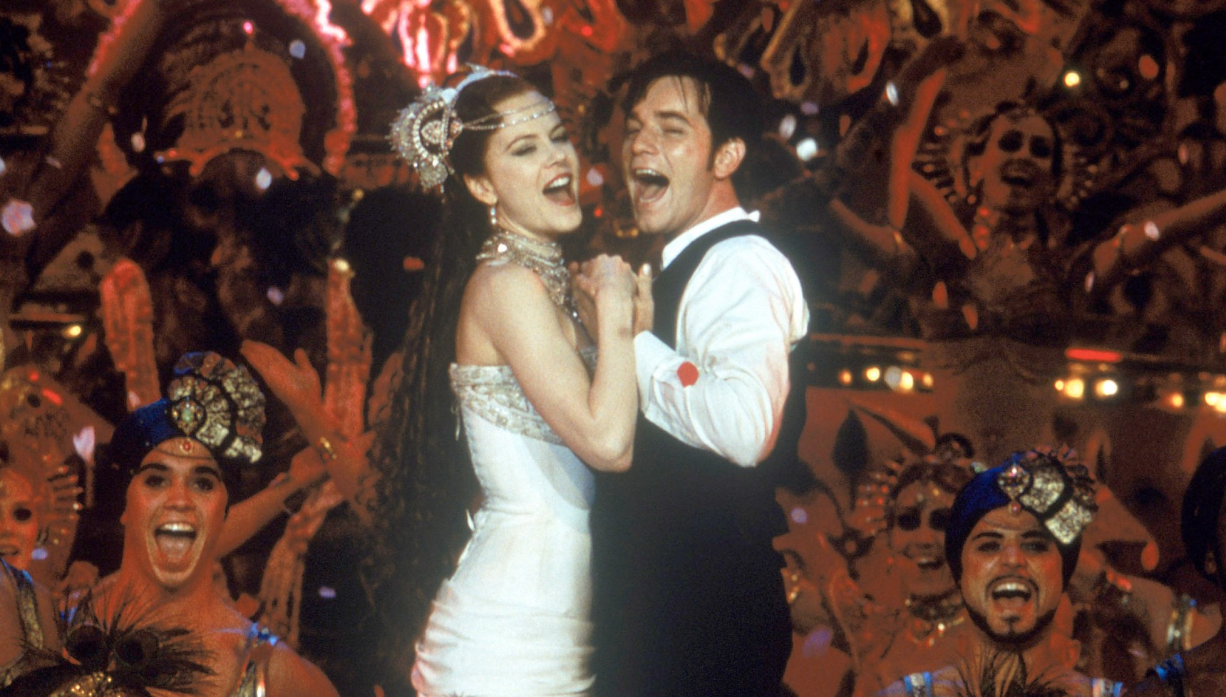 Nicole Kidman and Ewan McGregor hugging and singing in Moulin Rouge