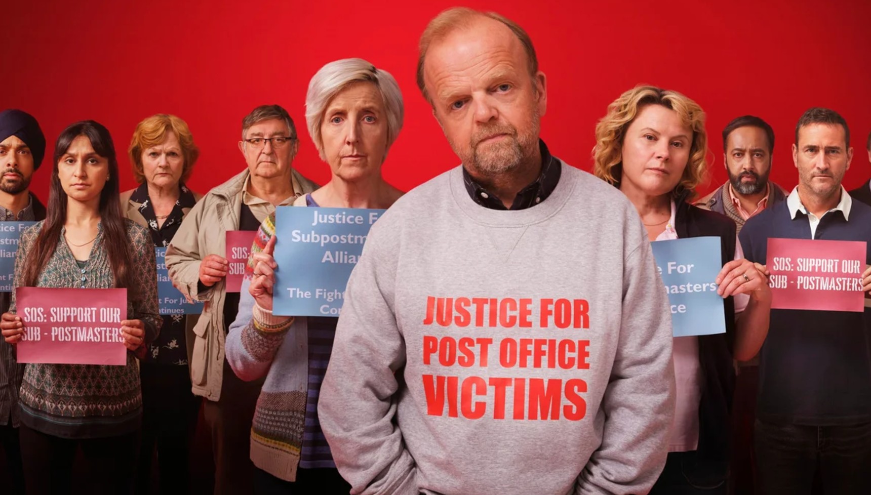 the cast of Mr Bates vs the Post Office wearing slogans