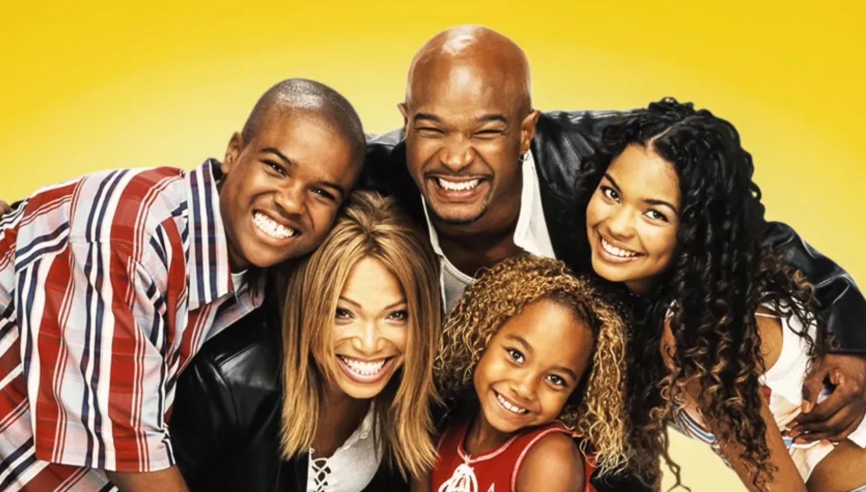 The cast of My Wife and Kids smiling and hugging against a yellow backdrop