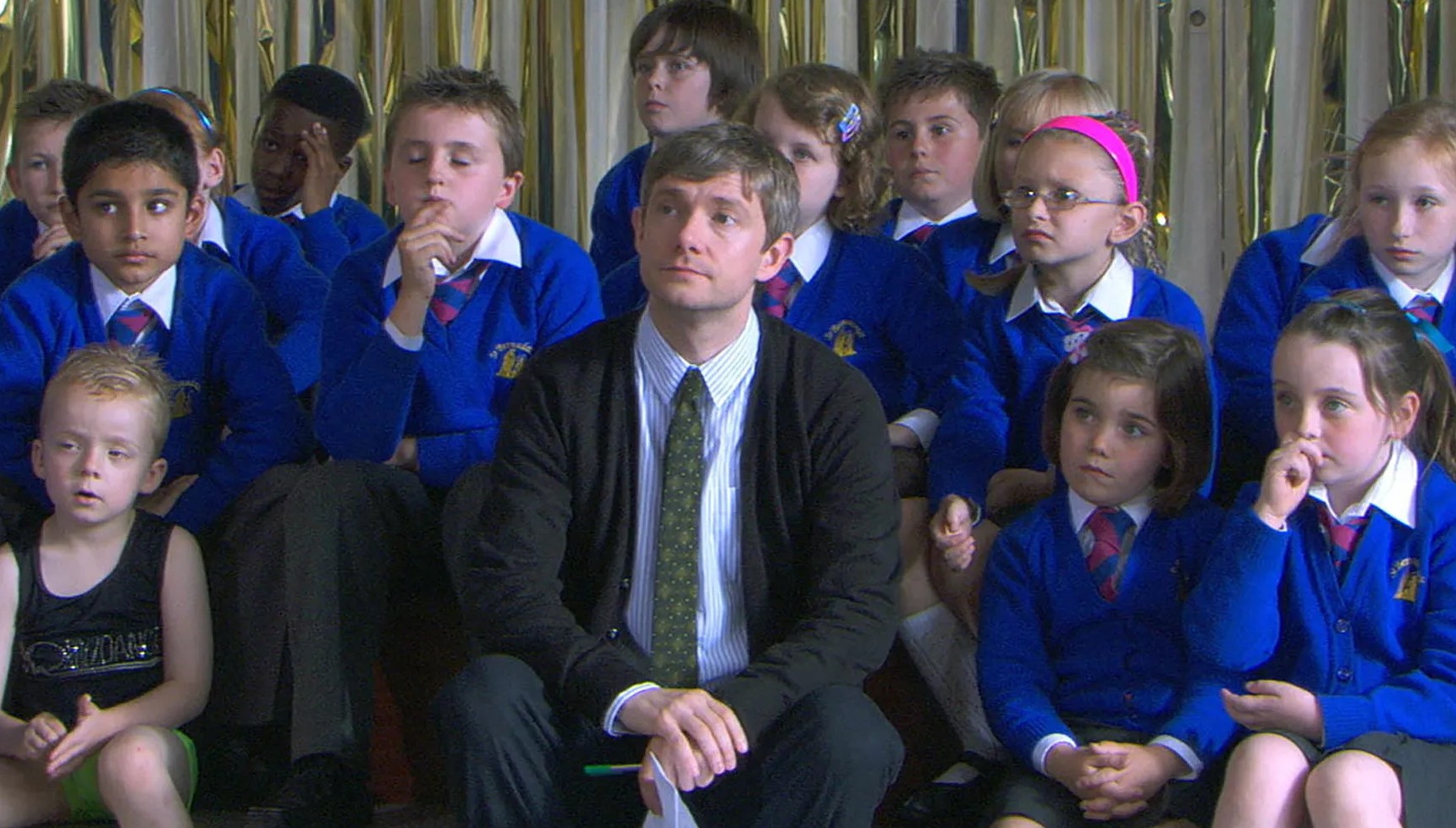 Martin Freeman surrounded by a group of school children
