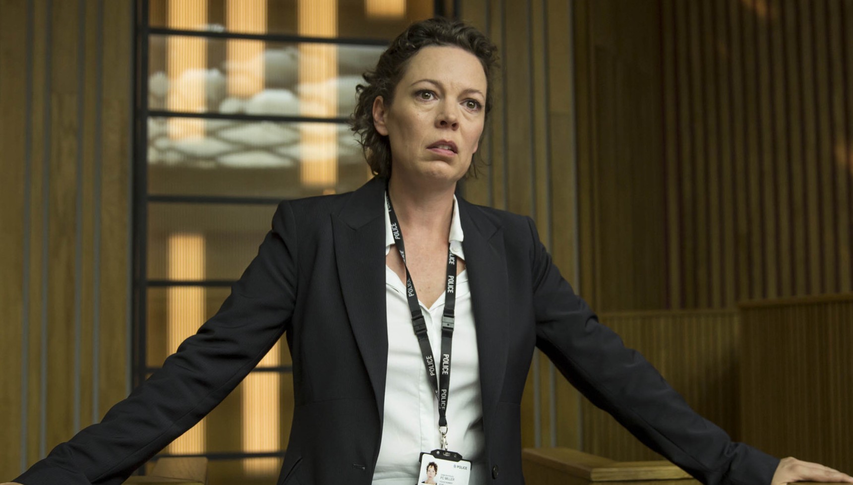 Olivia Colman looking tearfully as she leans on a table in Broadchurch