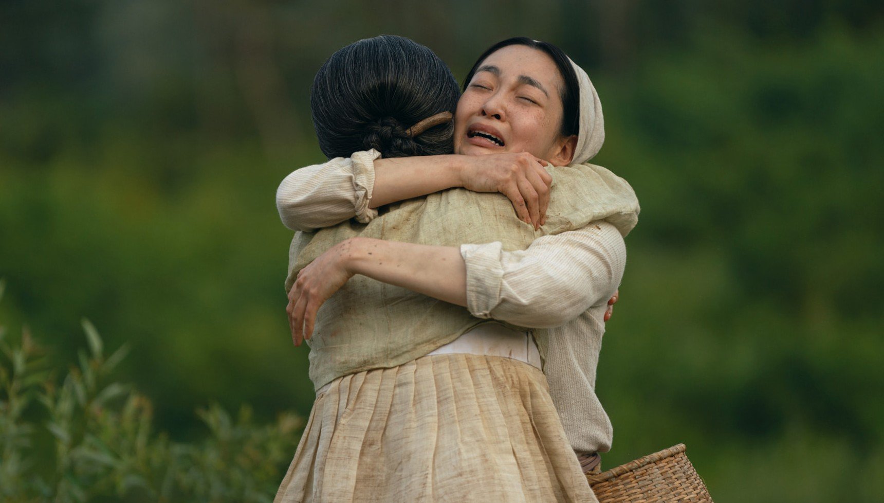 Two upset women hugging one another
