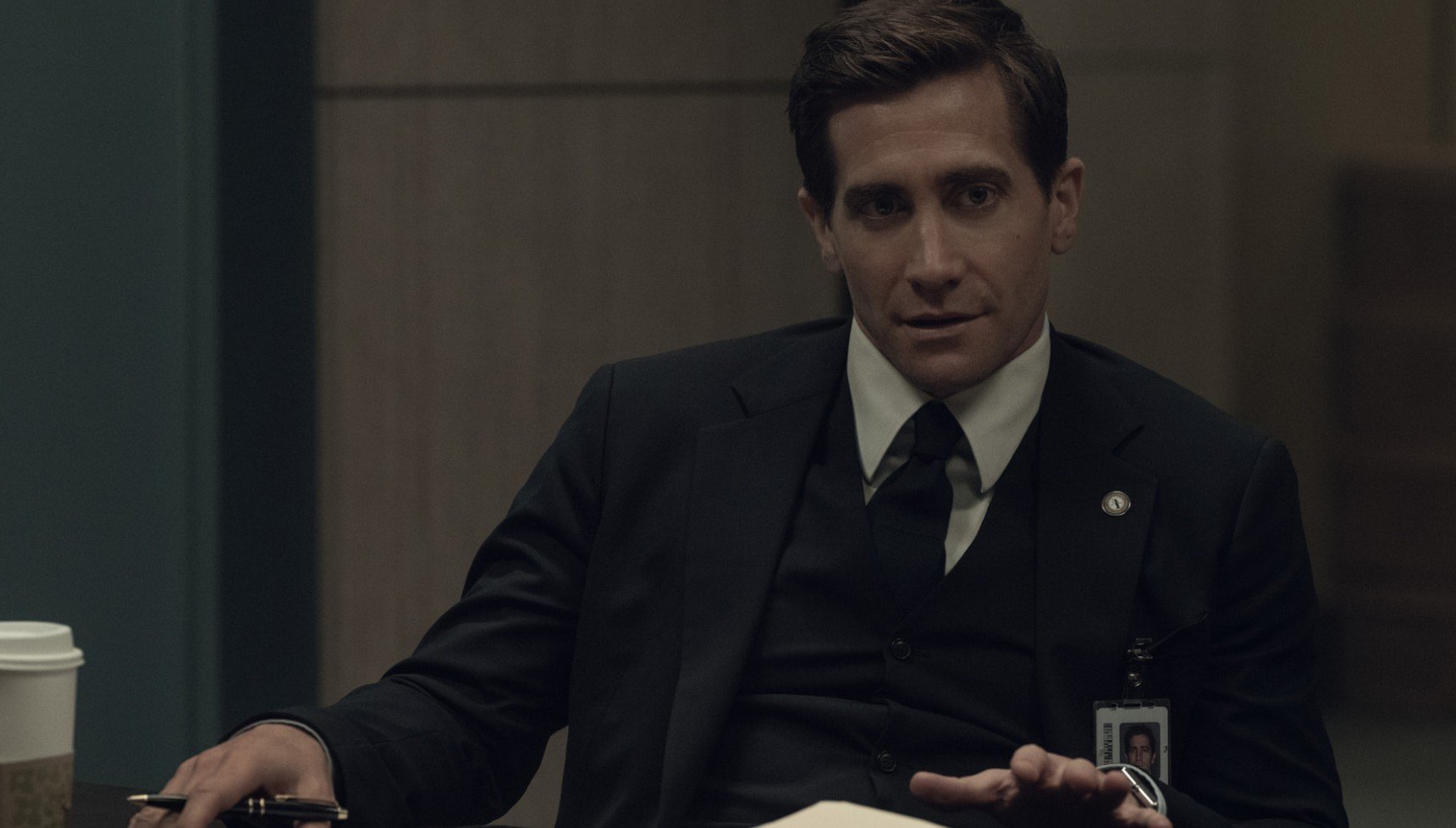 Jake Gyllenhaal's Presumed Innocent character talking whilst holding a pen