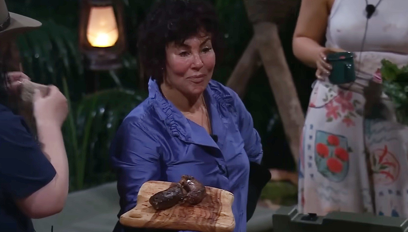 Ruby Wax holding a chopping board with a cooked emu neck