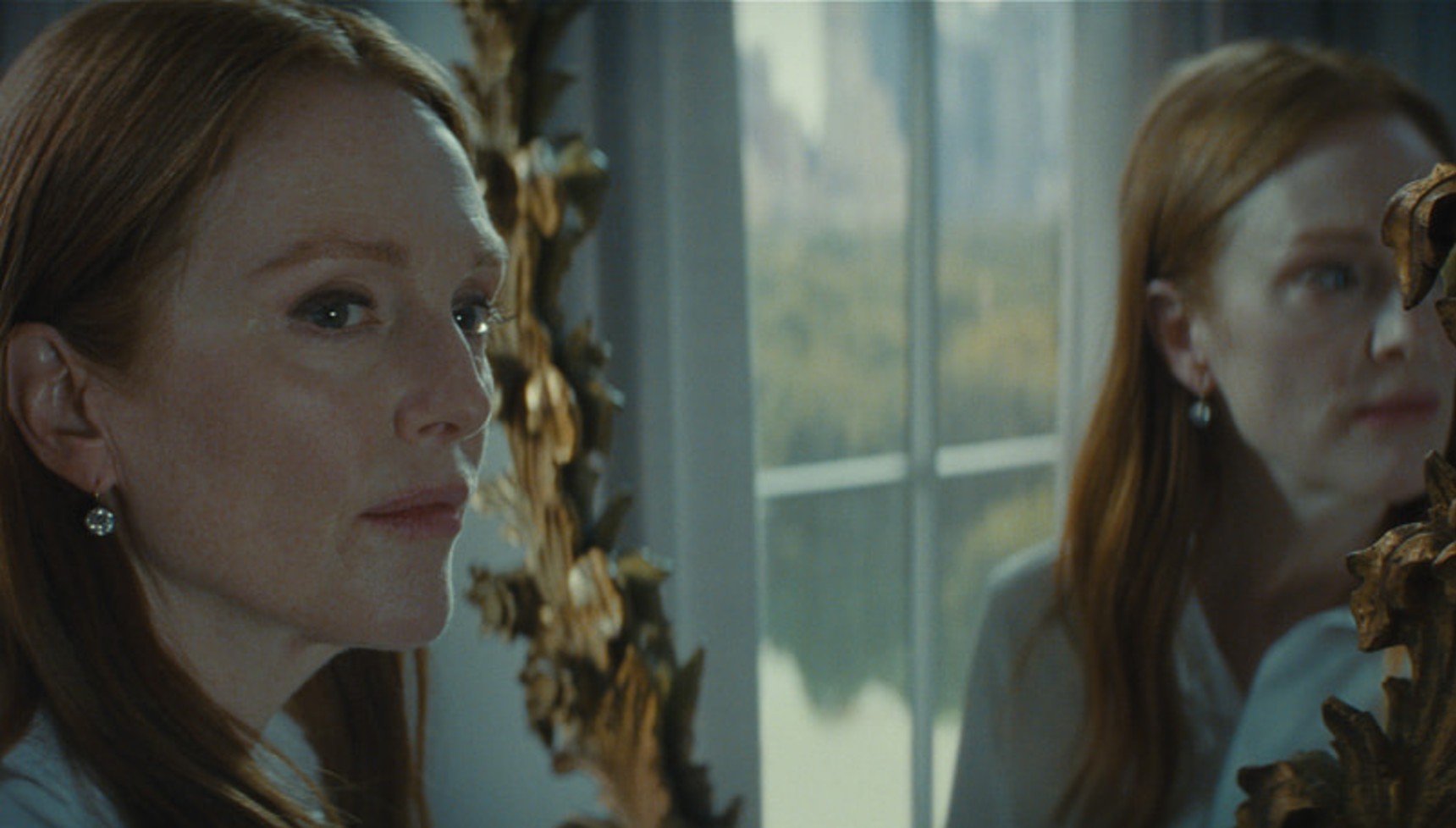 Julianne Moore's face reflecting back towards her in a mirror