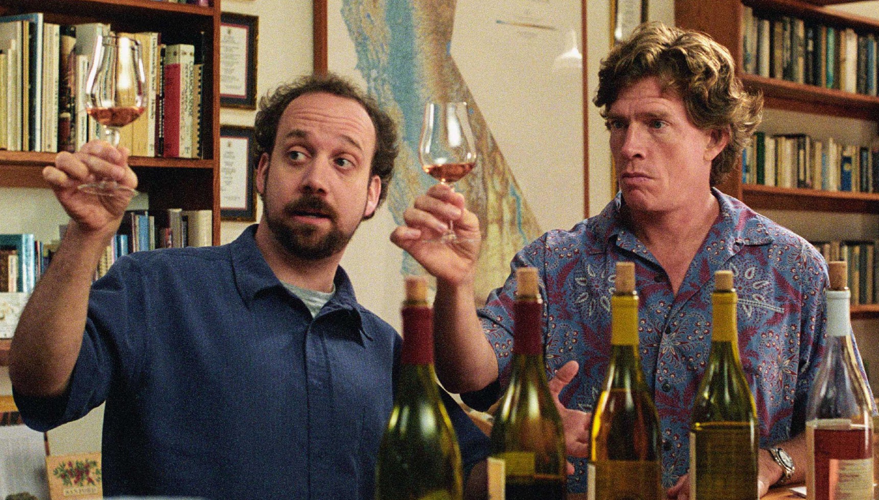 Paul Giamatti and Thomas Haden Church holding glasses of wine in Sideways