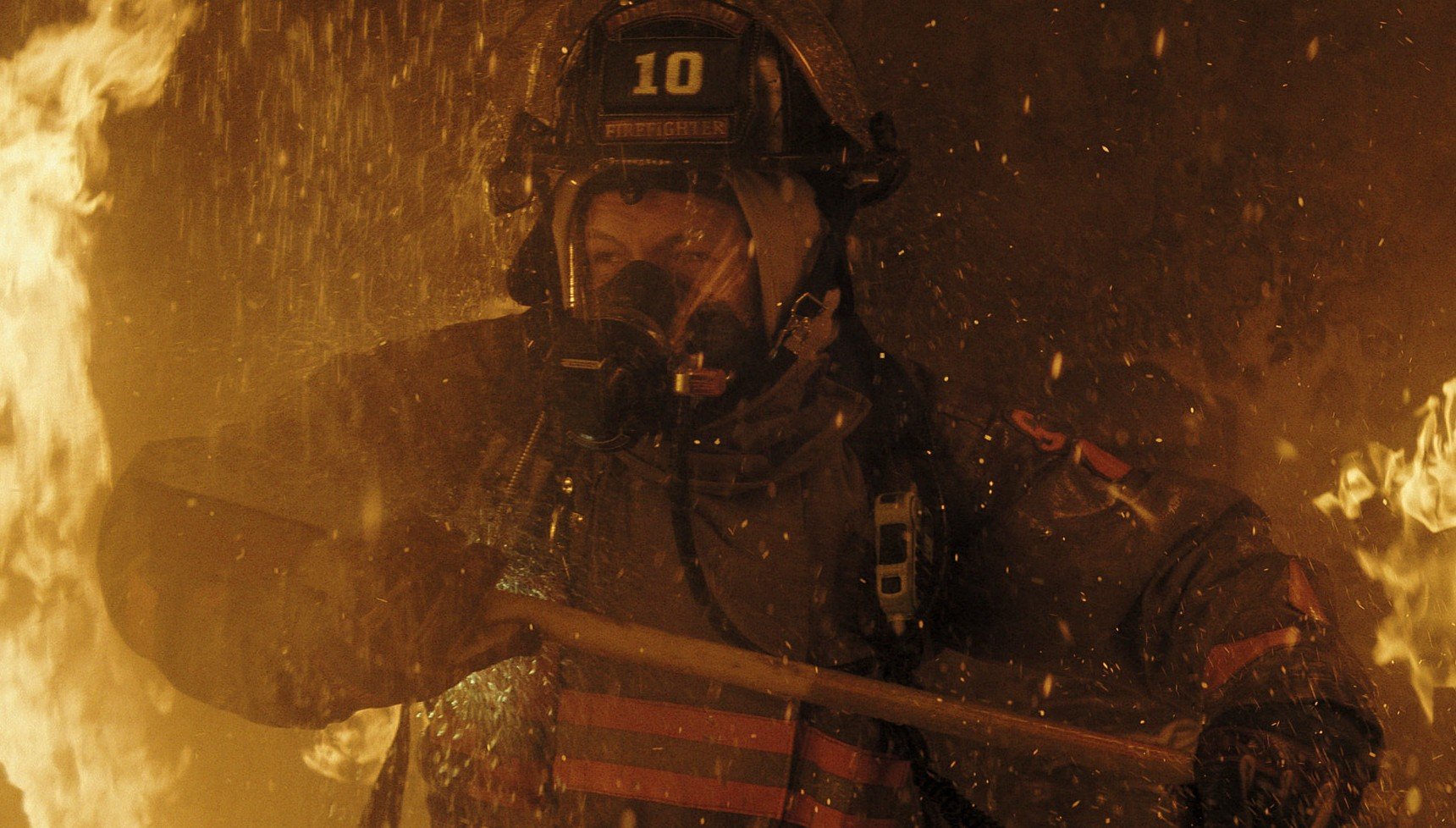 A firefighter contends with flames