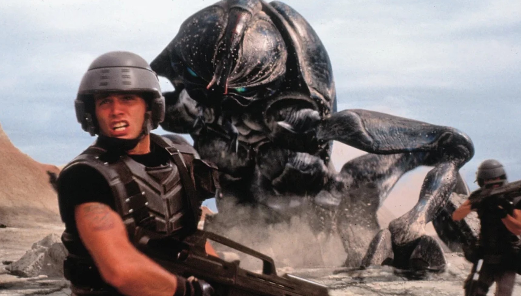 Johnny Rico running from an alien in Starship Troopers